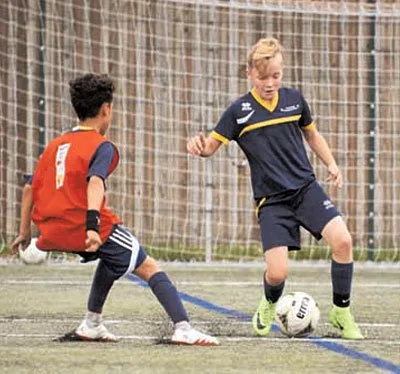 Two players challenging for the ball during a session